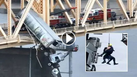 فيديو: شاحنة تنزلق من على جسر بعلو 80 قدما.. وتترك السائقة معلقة بالهواء!
